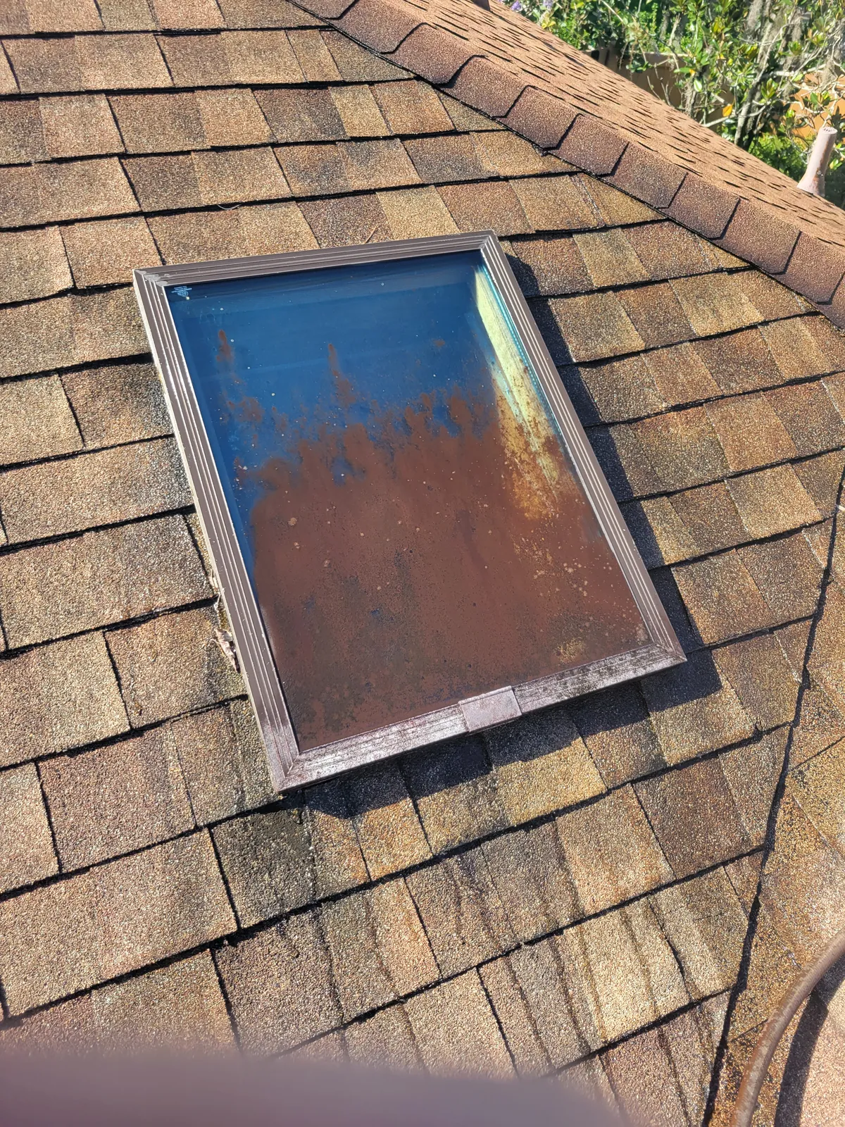 Before: Skylight on a shingle roof. Grime and oxidation removed without high pressure.